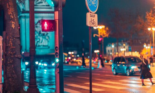 Champ élysées traffic ligts view from pedestrian crossing during night time.